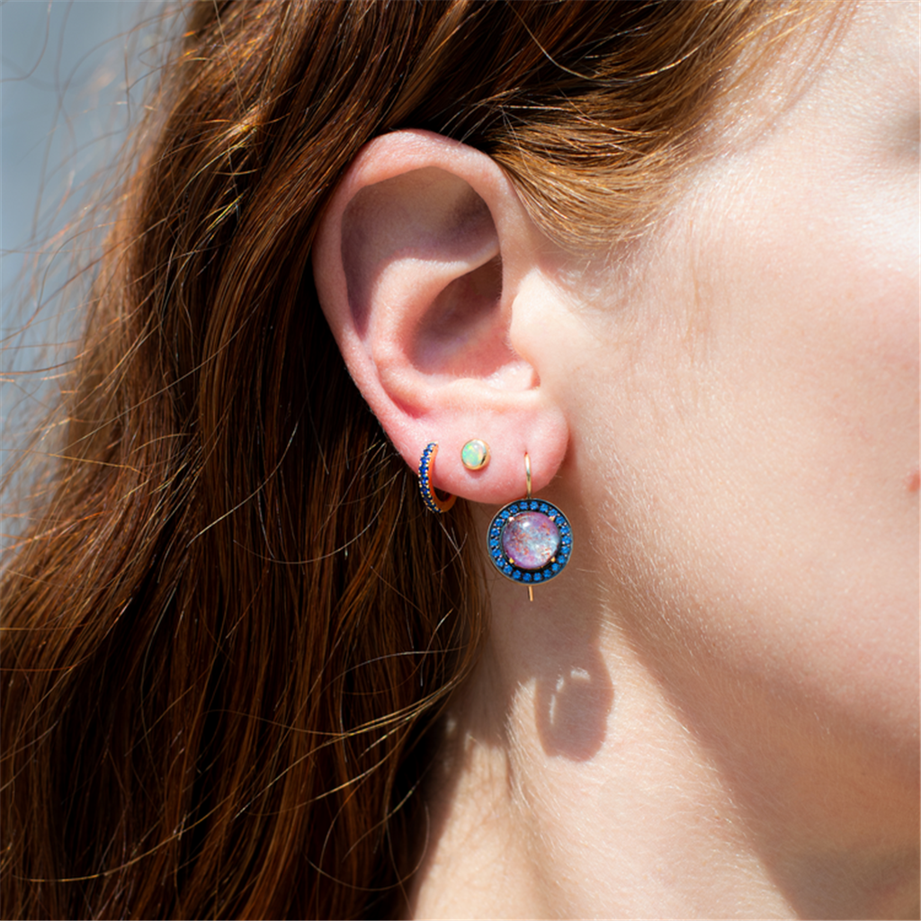 model wearing sapphire huggy earrings