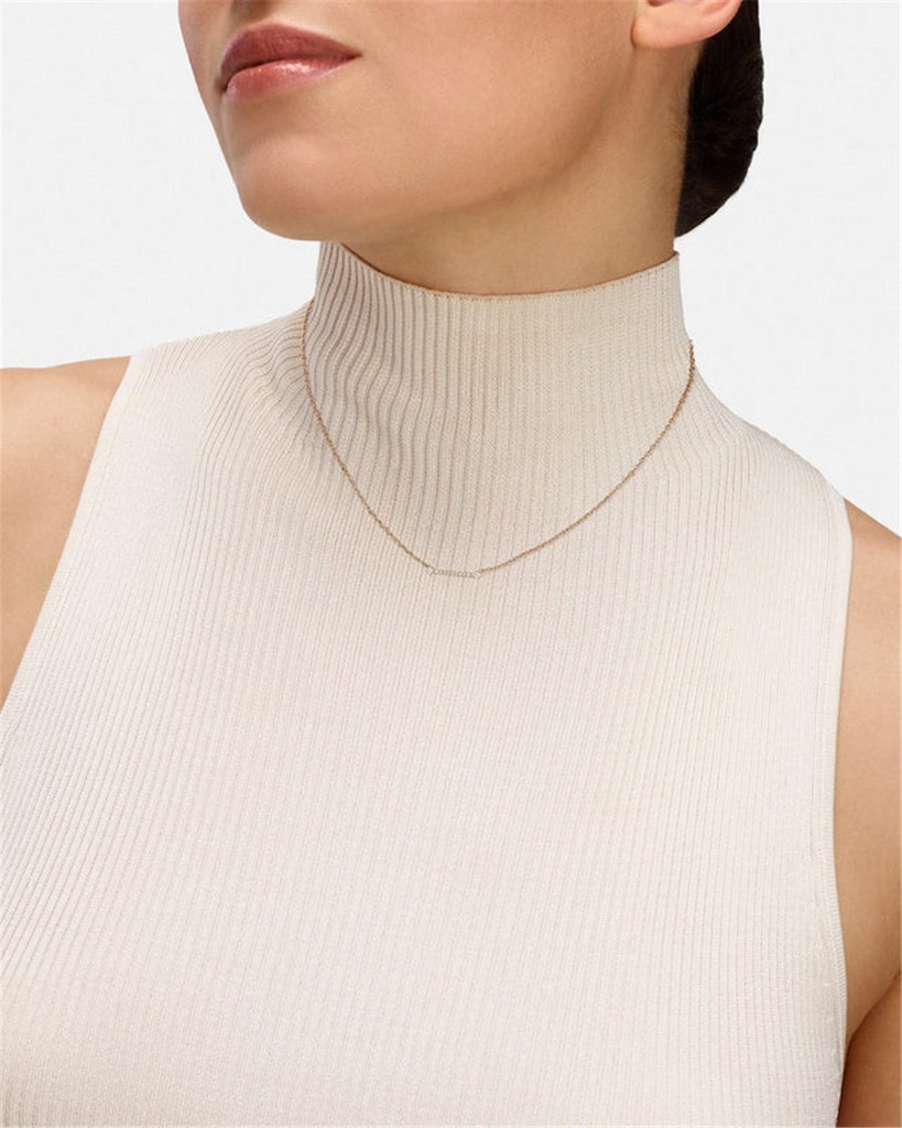 gold and diamond pendant necklace on model