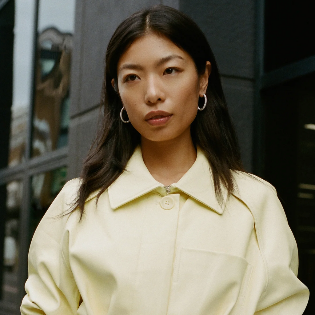 Model wearing gold oval florentine finish gold hoops