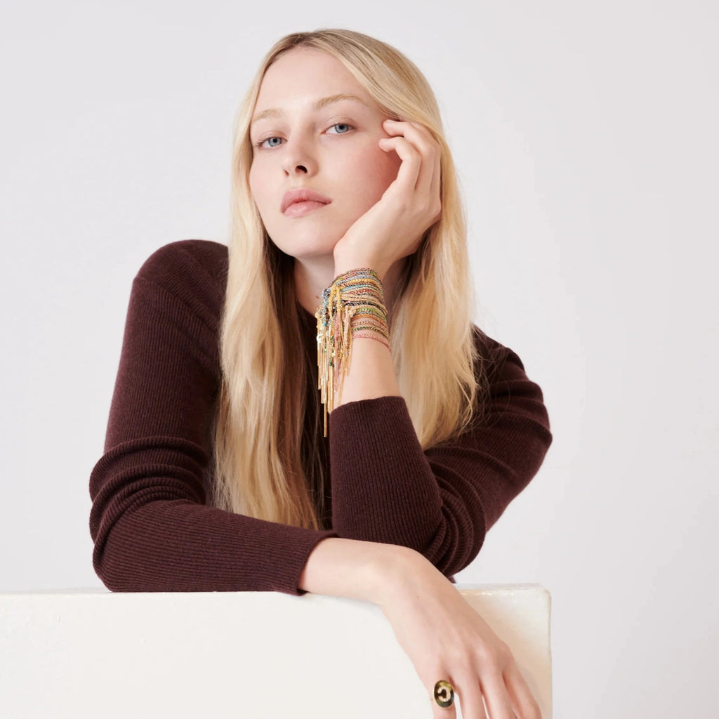 model wearing lucky bracelets and gold ring