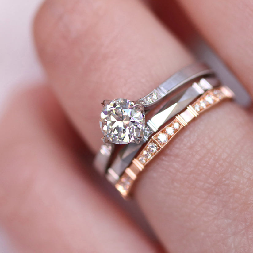 model wearing platinum diamond ring with 2 bands