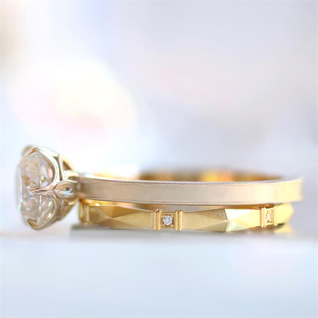 shows diamond solitaire ring and wedding band