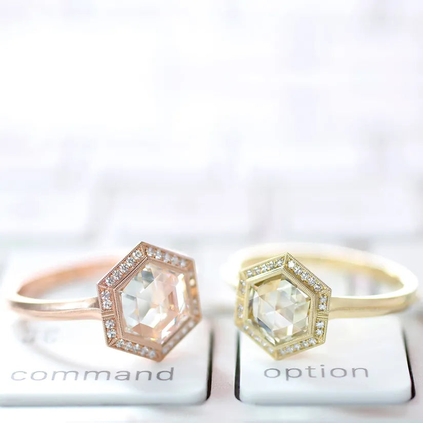 2 hexagon shaped diamond rigns one in gold and one rose gold