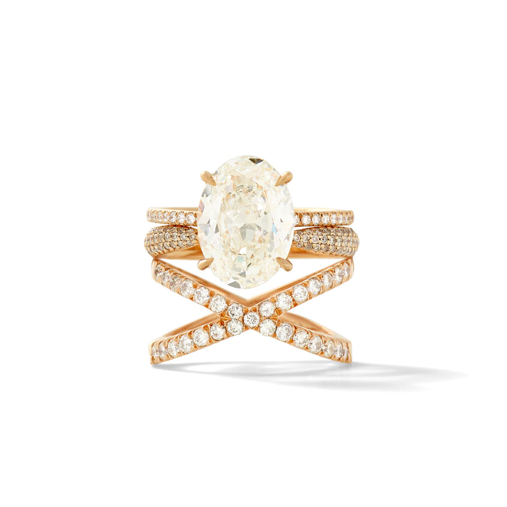 oval diamond ring stacked on diamond wedding bands