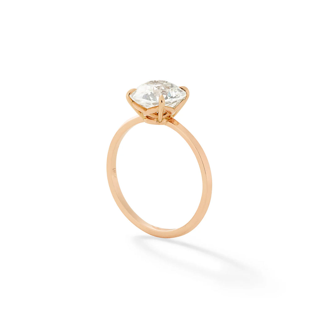 round solitaire and gold diamond ring standing up