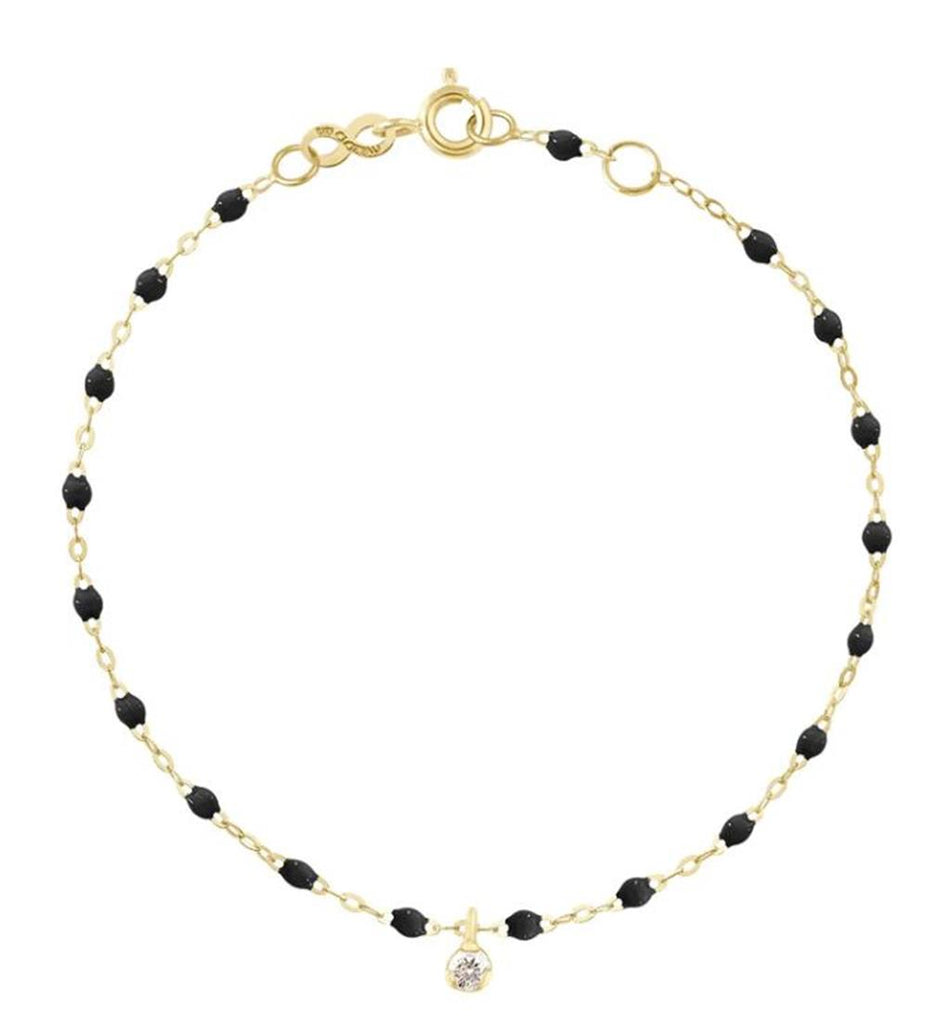 dainty gold bracelet with black beads one one hanging diamond