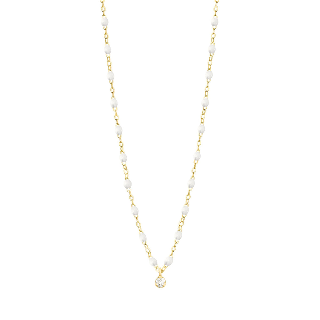 dainty gold and white beaded necklace with one diamond