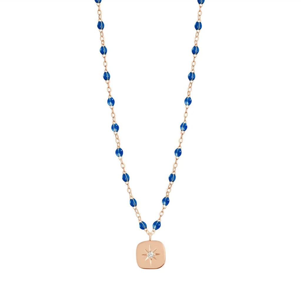 dainty gold and sapphire beaded necklace with gold charm with star and diamond in center