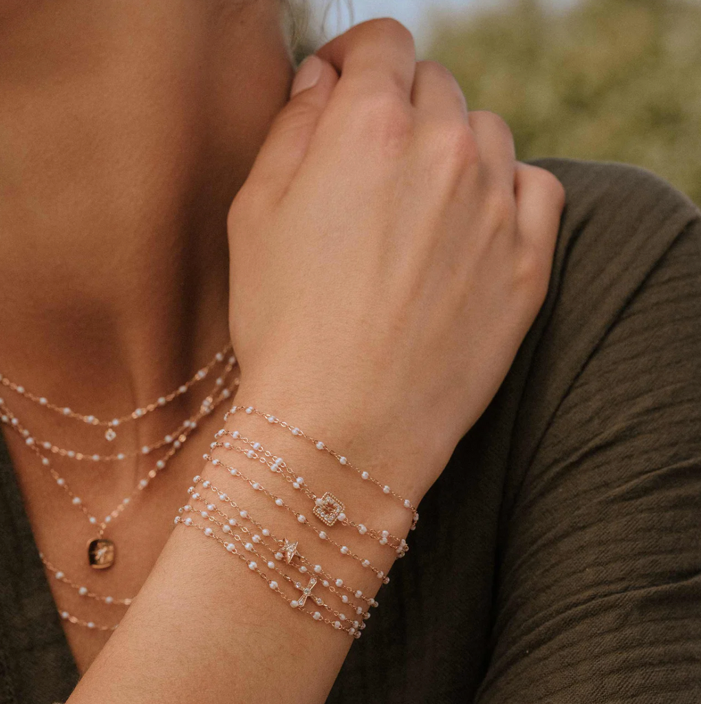 model wearing multiple opal beaded bracelets and necklaces 