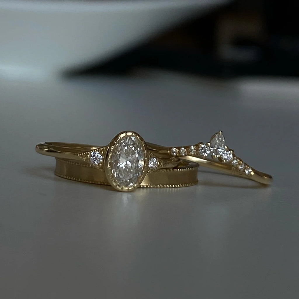 oval diamond ring stacked on gold band 
