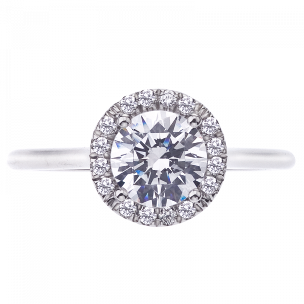 This micro pave diamond halo engagement ring has a high polish plain platinum shank. The halo has 16 round brilliant cut diamonds weighing 0.13 carats total
