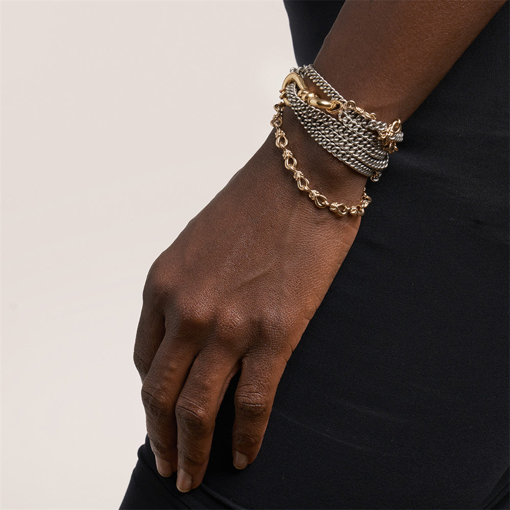 Model wearing gold knot lock and metal chain bracelets