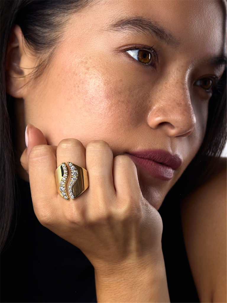 model wearing gold and diamond ring in open wave design