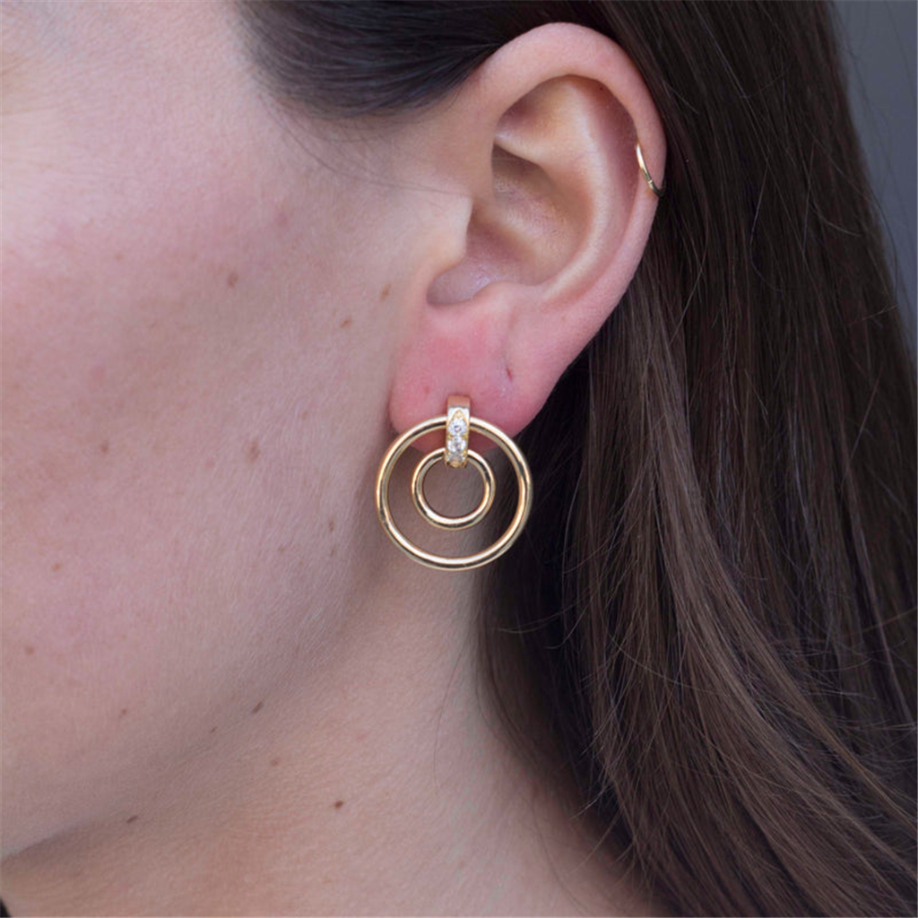 model wearing gold double hoop earrings