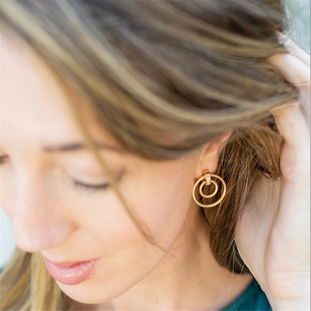 model wearing gold double hoop earrings