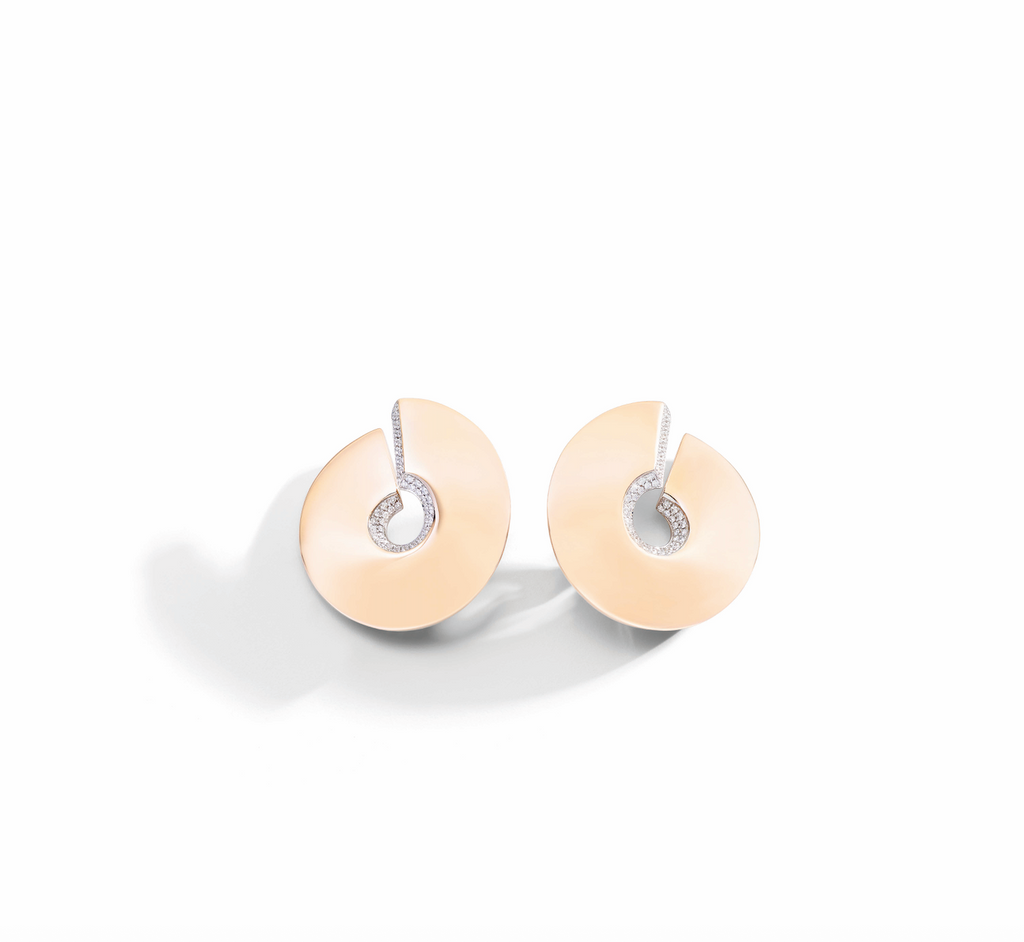 Pair of gold earrings on a white background