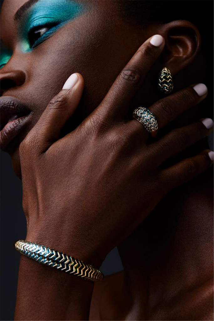 model wearing dome ring and earrings with zigzag pattern