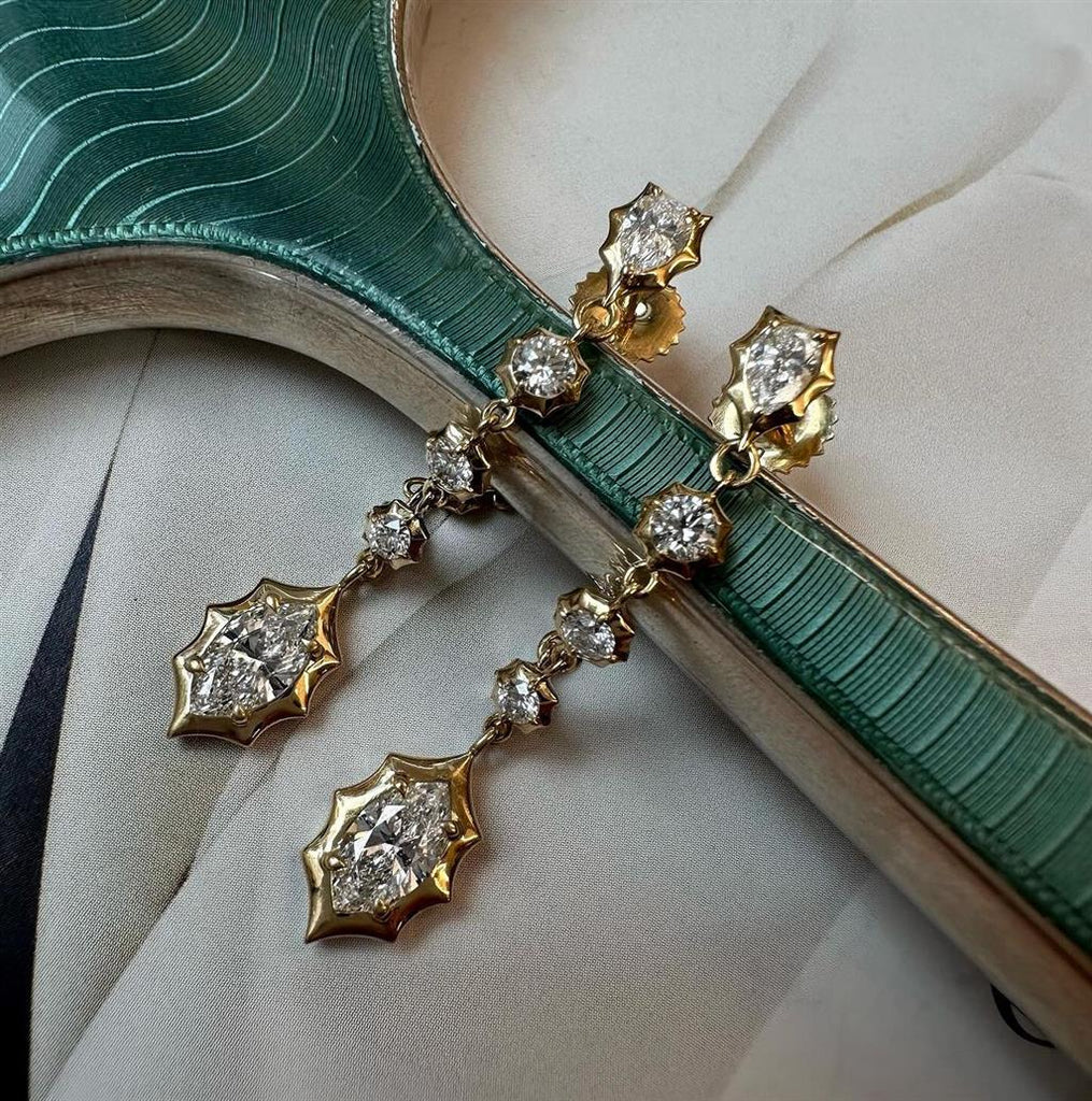 Diamond drop earrings with 1 Marquise Diamond, 
2 Pear-shaped Diamonds and 
14 Round Brilliant Cut Diamonds