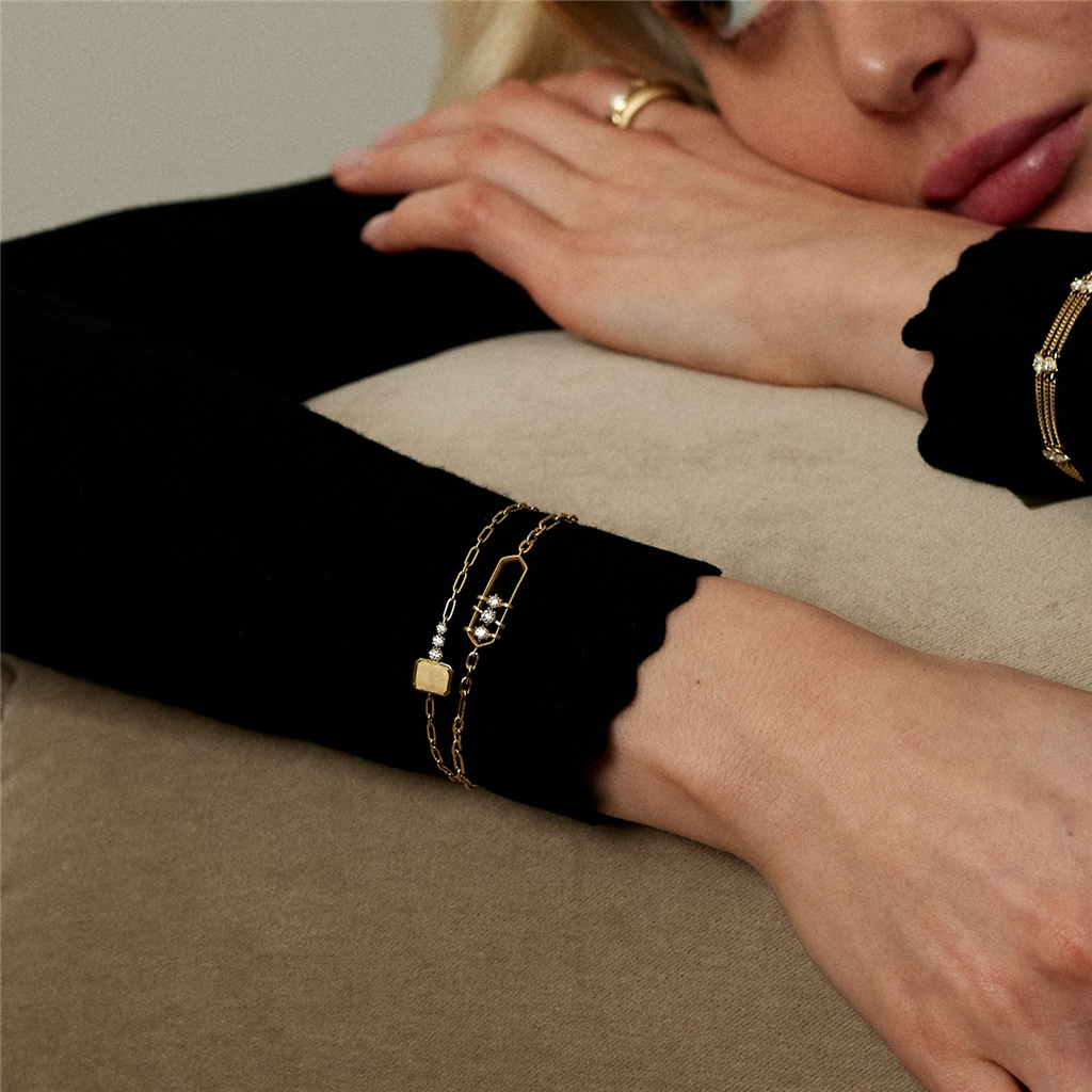 model wearing multiiple gold and diamond jade trau bracelets